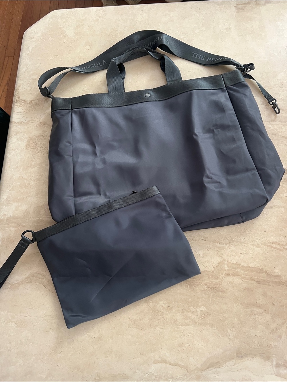 Nylon travel tote bag and matching detached zip pouch from The Peninsula Hotel